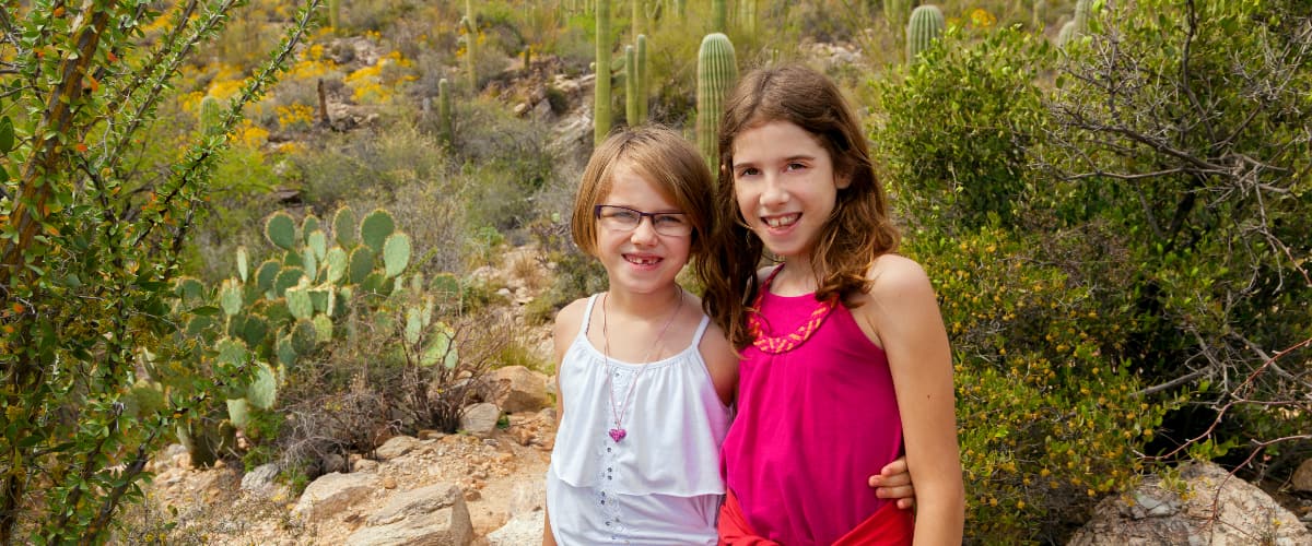 Sisters pose for a photo in the desert